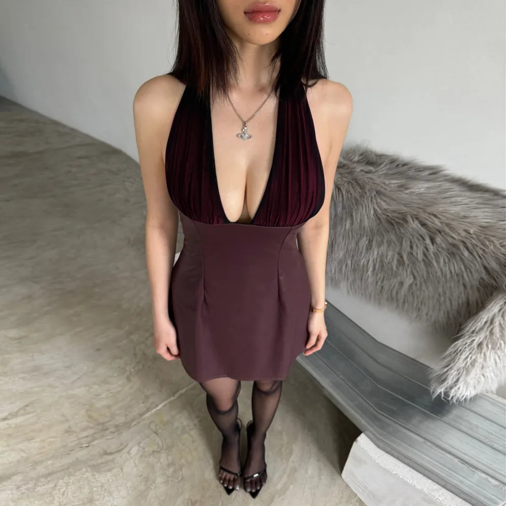 Woman wearing a deep neckline dress in a neutral setting