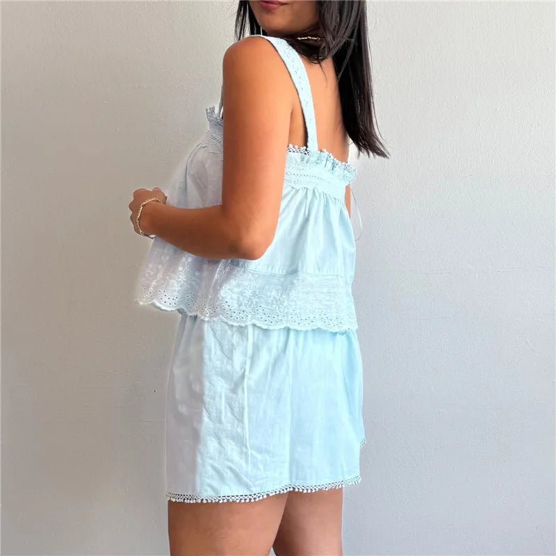Light blue lace dress worn by a person on a plain background