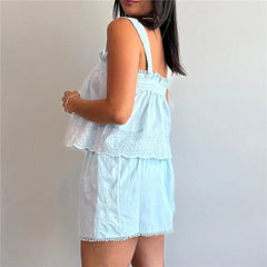 Light blue lace dress worn by a person on a plain background