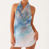 Woman wearing a sleeveless dress with blue and white abstract pattern