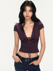 Woman wearing a purple top with lace details