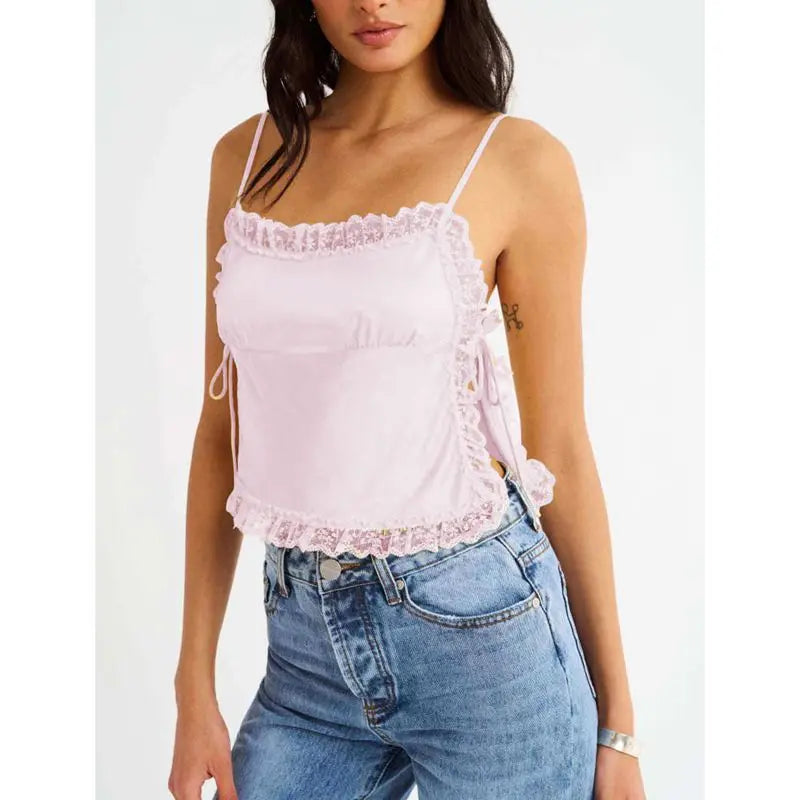 Model displaying a short lace trim satin cami top with an open back.