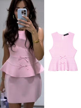 Pink peplum top worn by a person and shown from multiple angles