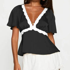 Model displaying a short lace trim flare short sleeve top with a V-neck.