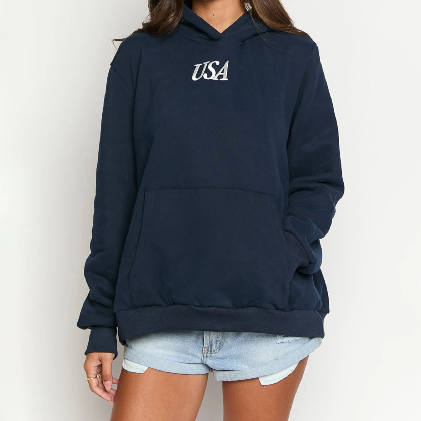 Person wearing a navy blue hoodie with 'USA' text