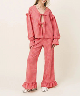 Red checkered pajama set worn by a person on a beige background