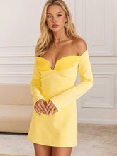 Woman wearing a yellow off-shoulder dress in an indoor setting