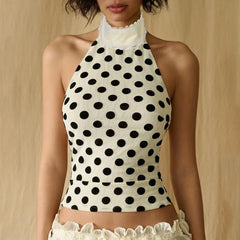 Polka dot halter top with white lace trim on a neutral background