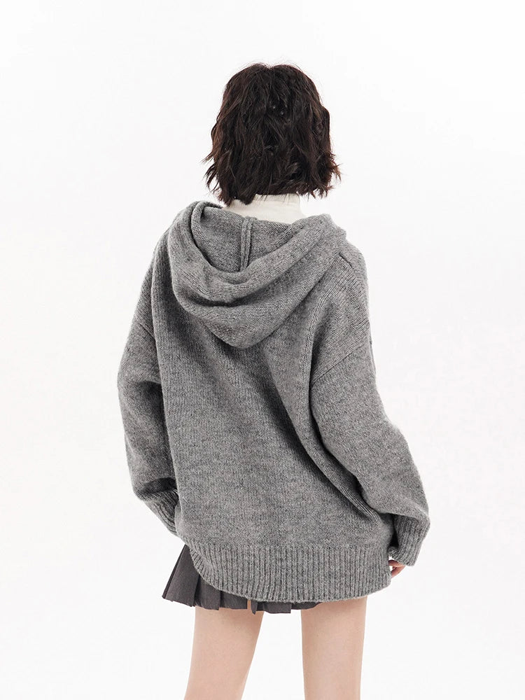 Person wearing a gray oversized hoodie