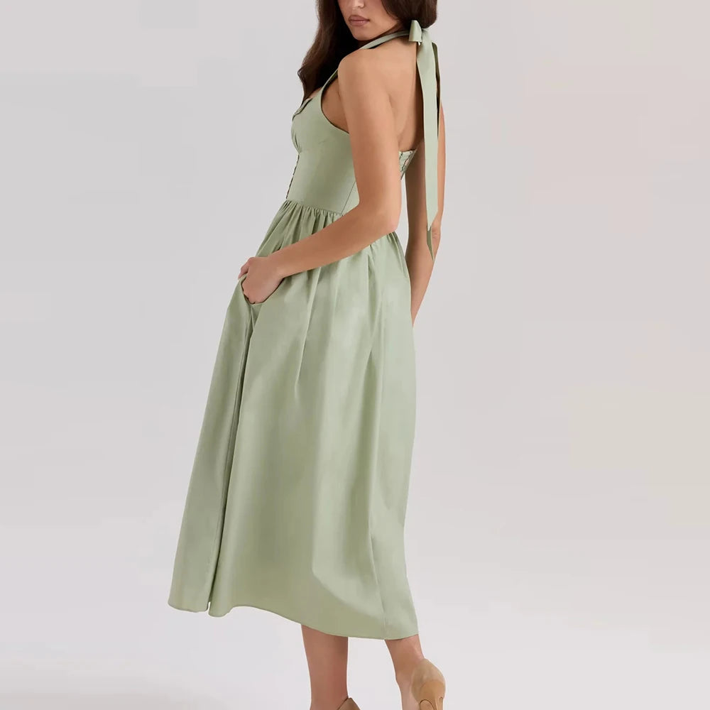 Women's green embroidered halter midi dress with A-line silhouette.