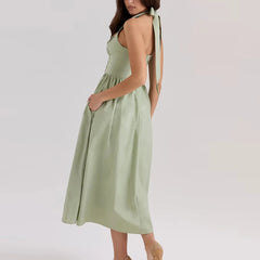 Women's green embroidered halter midi dress with A-line silhouette.