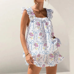 Woman wearing a floral dress with blue ribbons
