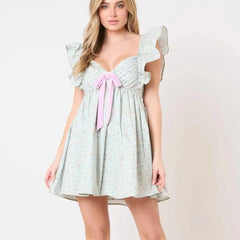 Women's charming green mini dress with bow and ruffles.