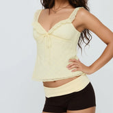 Woman wearing a light yellow top and black shorts