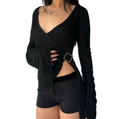 Black long-sleeve top with a belt and black shorts