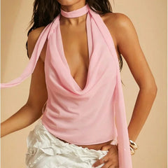 Woman wearing a pink halter top with a beige background