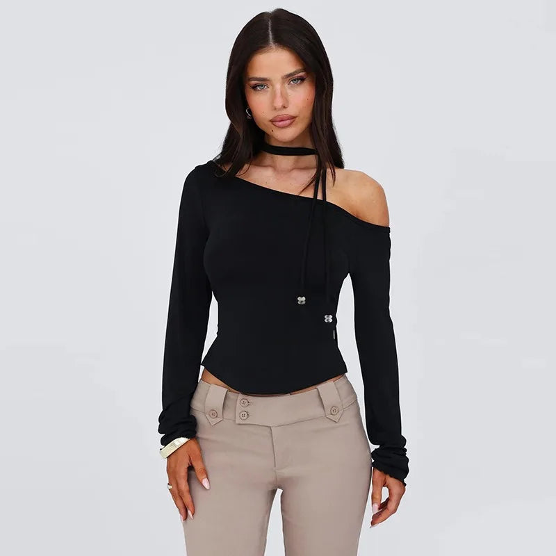 Woman wearing a black off-shoulder top and beige pants