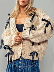 Beige knitted cardigan with black ribbons
