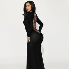 Woman wearing a black evening gown with sheer side panels