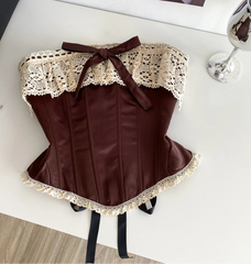 Brown corset with lace details on a white surface