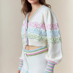 Woman wearing a white cardigan with colorful patterns