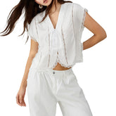 Woman wearing a white lace top and pants