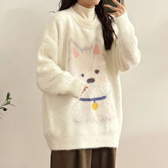Person wearing a white sweater with a cartoon dog design against a plain background