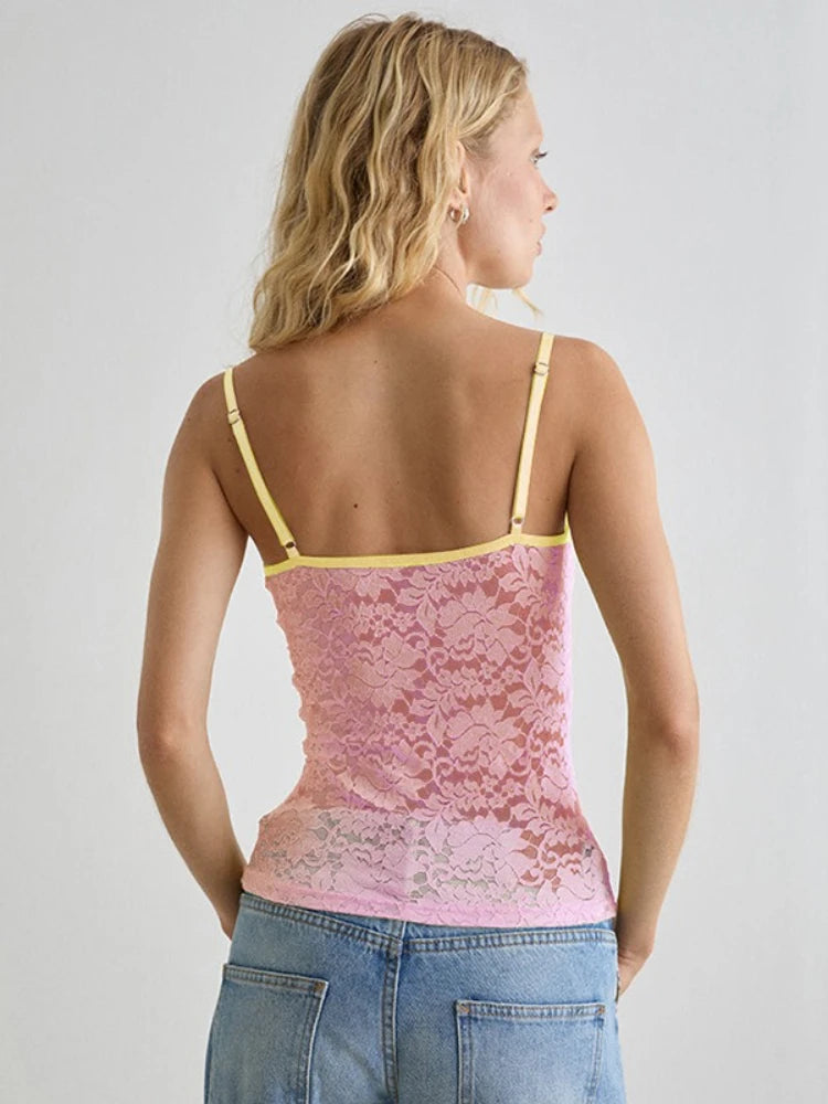 Woman wearing a pink lace camisole with yellow straps - back view