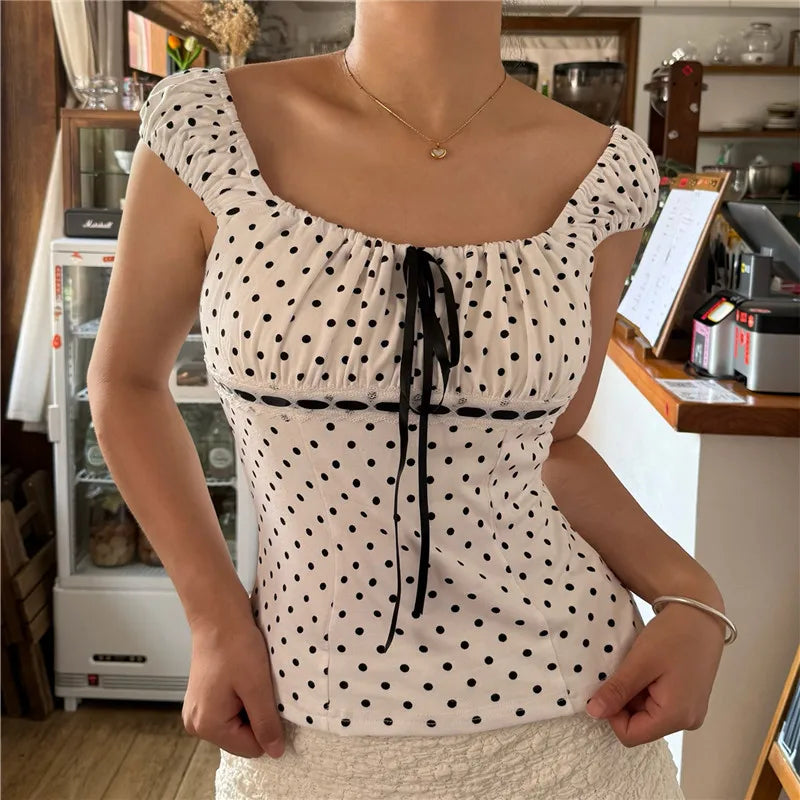 Woman wearing a polka dot top in a casual indoor setting