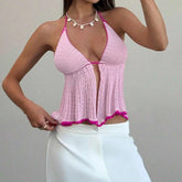 Woman wearing a pink crochet top with white pants