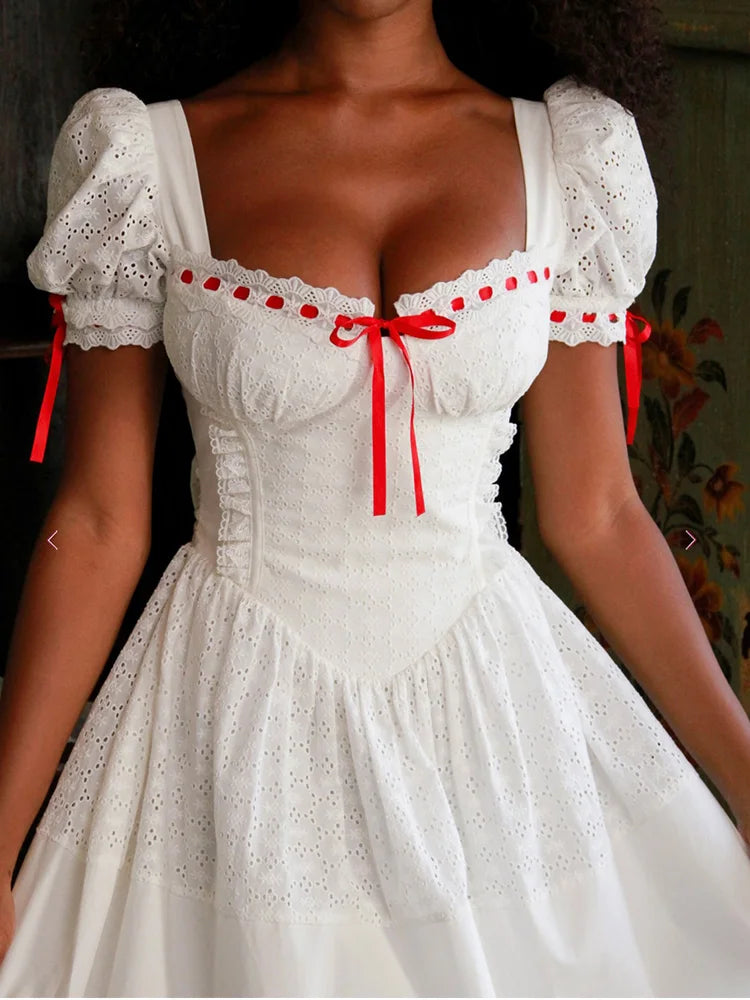 White dress with red accents, puff short sleeves worn by a model