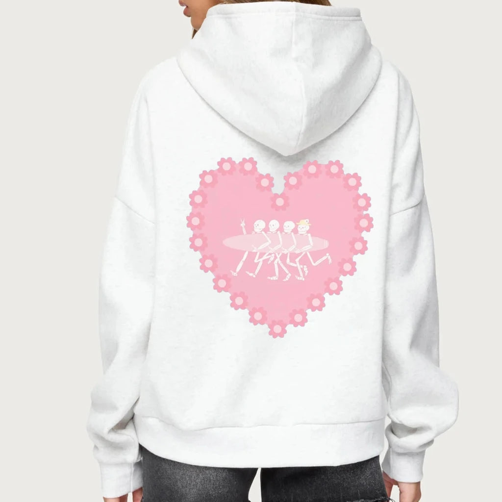 White hoodie with a pink heart design on the back against a white background