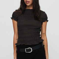 Women's smocked short sleeve top with V-neck and bow detail.