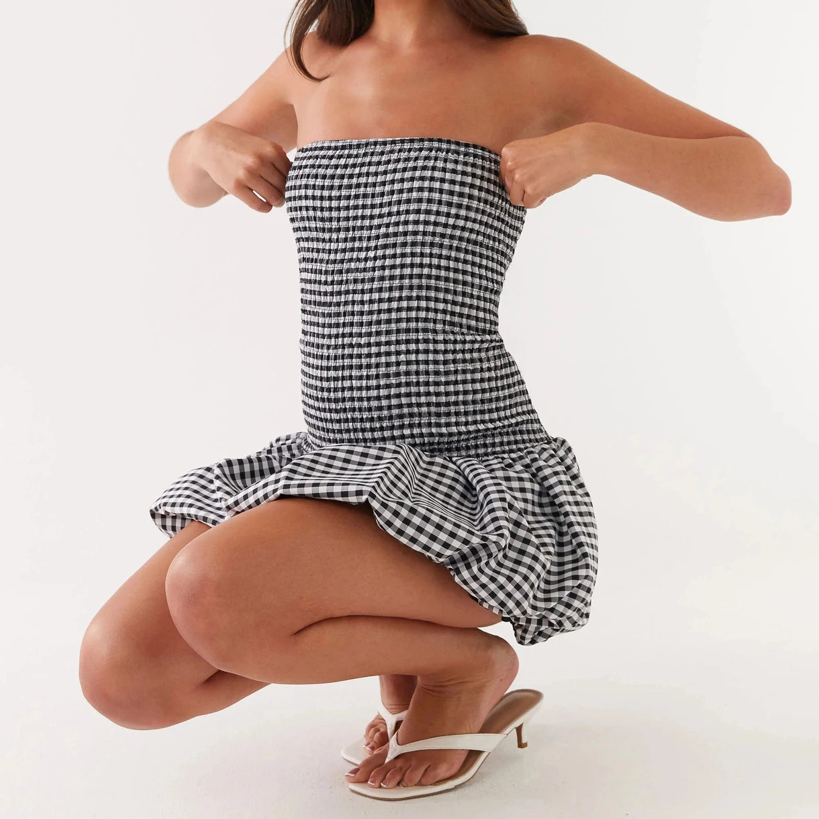 Woman wearing a black and white checkered strapless dress