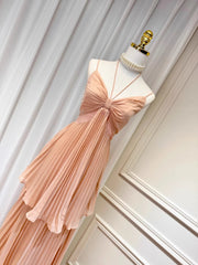 Pink dress on a mannequin against a white wall
