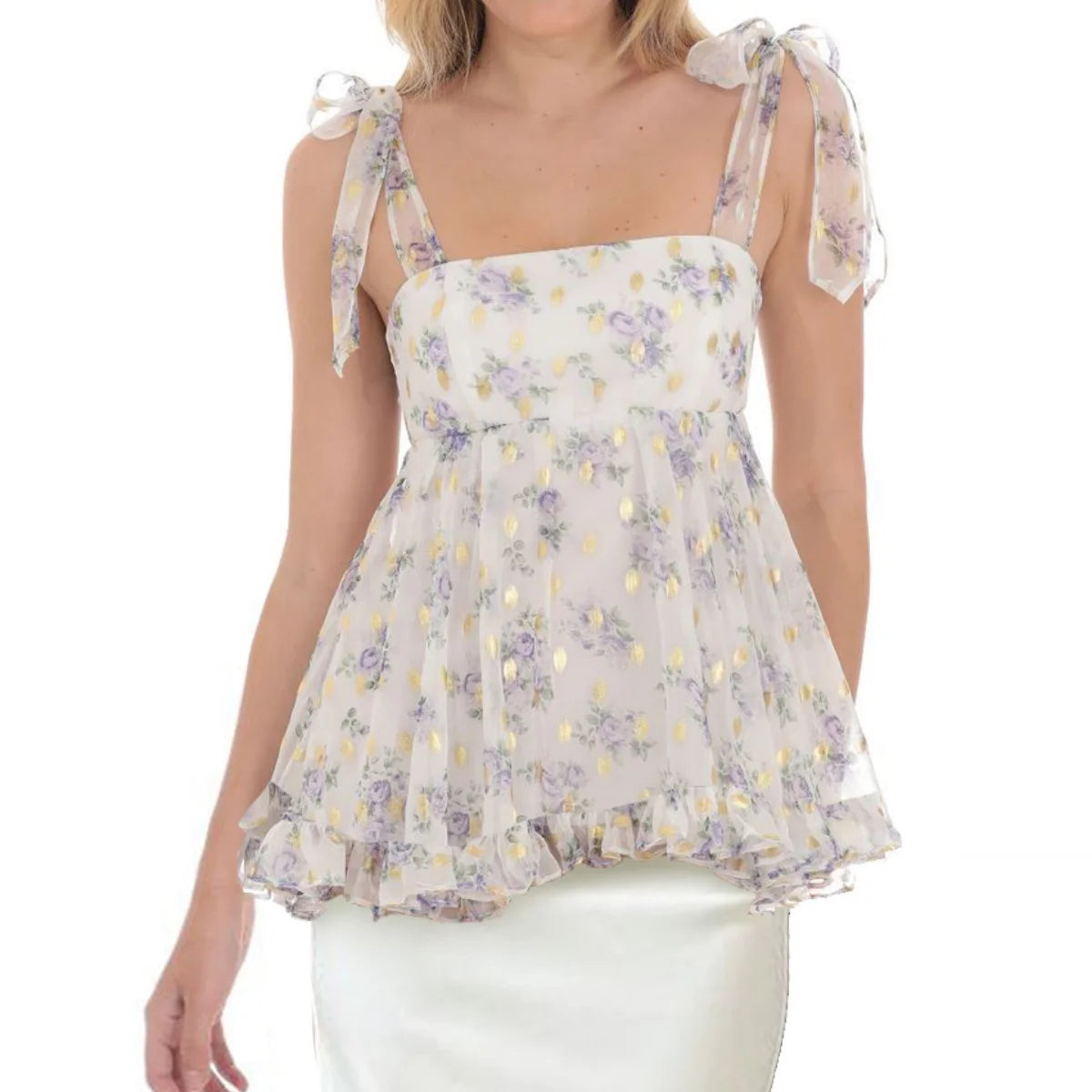 Woman wearing a floral blouse with sheer sleeves