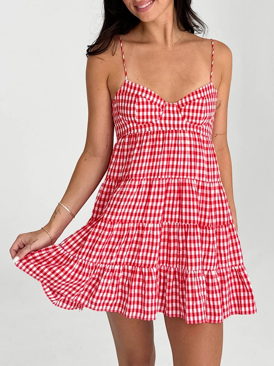 Red and white checkered dress worn by a model on a plain background