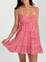 Red and white checkered dress worn by a model on a plain background