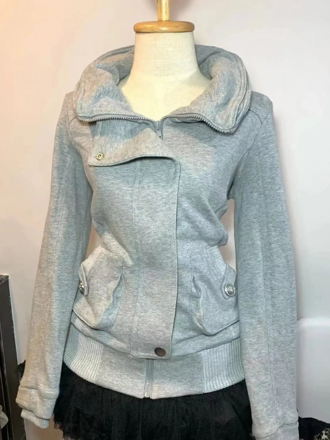 Light gray jacket on a mannequin against a white background