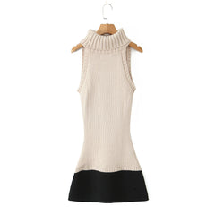 Beige sleeveless dress with black hem on a wooden hanger against a white background