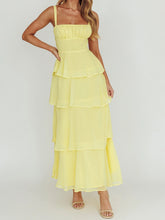 Woman wearing a yellow tiered dress