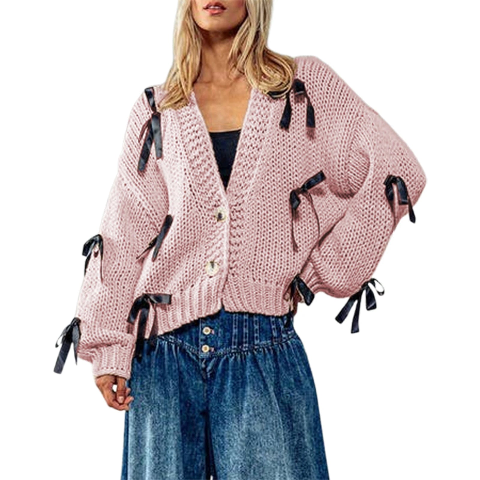 Pink knitted cardigan with black ribbons worn by a model