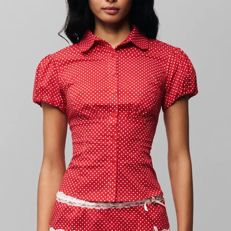 Women's polka dot button down lapel top with puff sleeves.