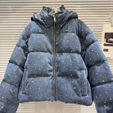 Blue puffer jacket with silver embellishments on a neutral background