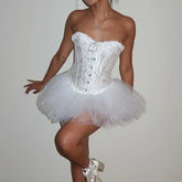 White corset and tutu dress worn by a model on a plain background