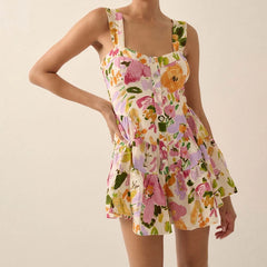 Woman wearing a colorful floral dress against a beige background