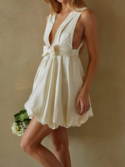 Woman wearing a white dress with a belt- side view