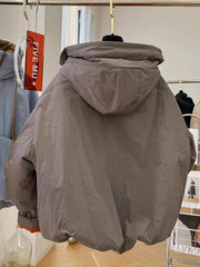 Gray hooded jacket hanging on a rack