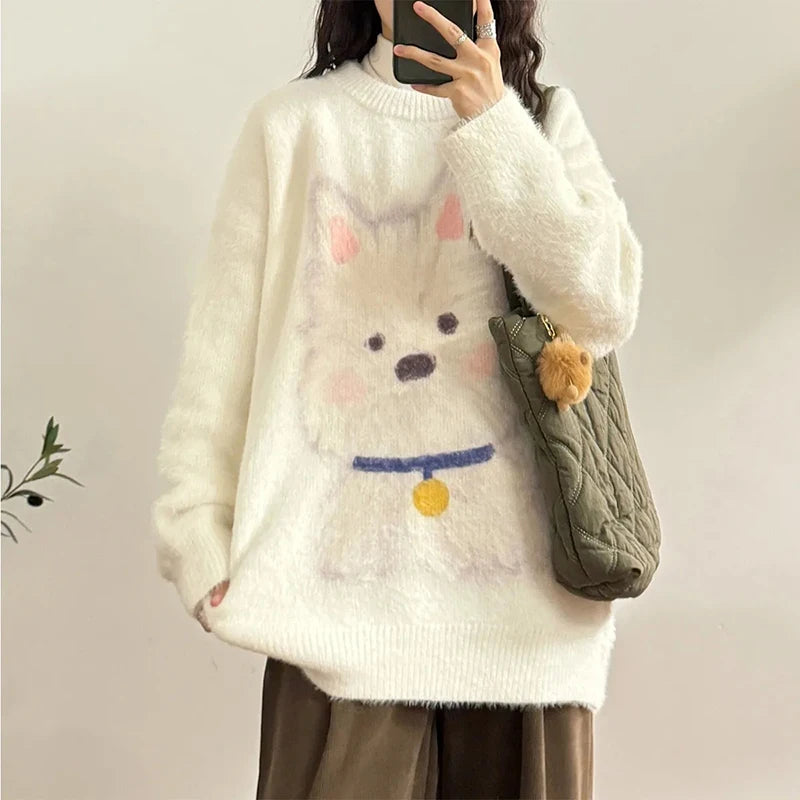 Person wearing a white sweater with a cartoon dog design, holding a green bag.