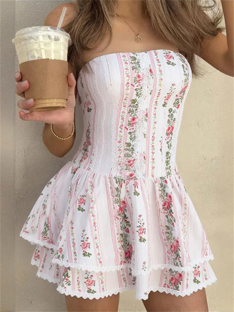 Women's white floral printed mini dress with a slash neck, backless detail, and sheath silhouette.